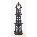 A Coalbrookdale style cast iron stick stand, 20th century, with a circular mirror set within a