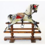 An early 20th century dapple grey rocking horse by 'G & J Lines', with applied horse hair mane and