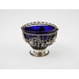 An 18th century white metal sugar bowl, circa 1780, the cage form bowl with blue glass liner,