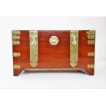 A 20th century Oriental camphor wood trunk, of rectangular form, with ornate brass fittings,