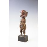 A Nkisi Fetish Voodoo figure, mounted on a later base with collection label, 36cm