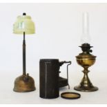 Two Victorian brass oil lamps, including a reeded column lamp with yellow glass shade, a second