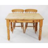 A Victorian style pine slab top kitchen table, with a single frieze drawer, raised upon turned legs,