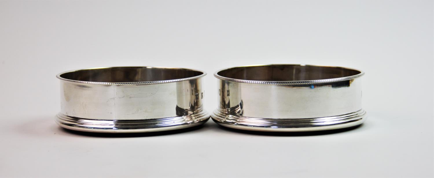 A pair of silver mounted bottle coasters, P H Vogel & Co, Birmingham 1998, of circular plain - Image 2 of 2