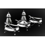A George V silver condiment set, Walker & Hall, Birmingham 1925, comprising: a pair of