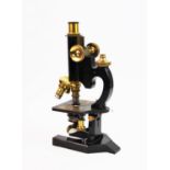 An early 20th century R & J Beck microscope, with brass fittings and three additional lenses,