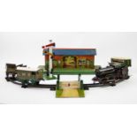 A Hornby clockwork 'O' gauge railway with accessories, comprising: a station platform, a level