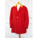 An eventing red riding jacket, the woollen jacket with yellow collar, applied with gilt metal