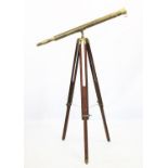 A 19th century style brass telescope, 20th century, mounted upon a hardwood tripod with brass