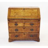 A George II walnut and mahogany cross banded bureau with fall front enclosing a recessed interior,