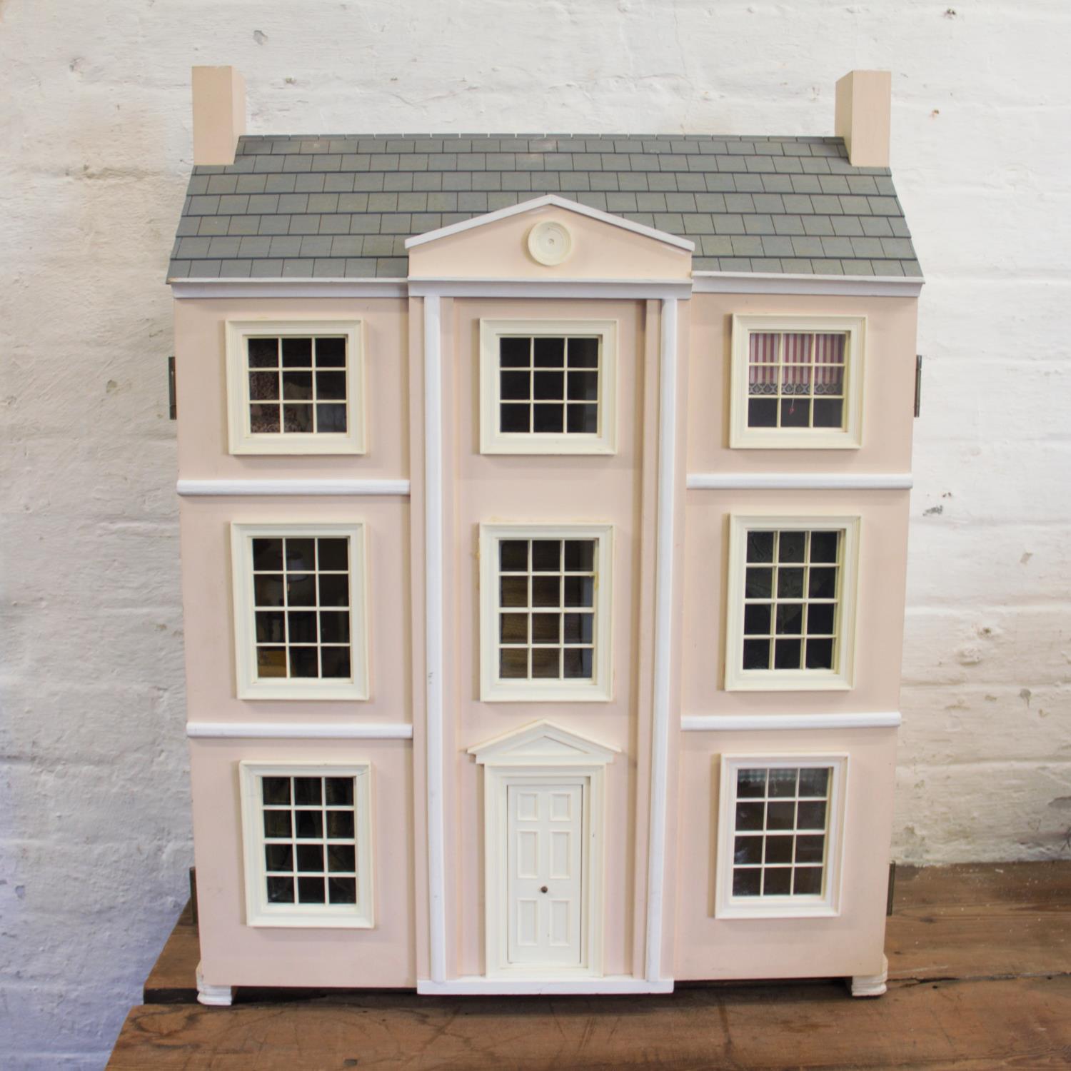 A style dolls house, 20th century, the hinged front with eight windows and a central fro