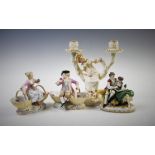 A pair of German porcelain figural pot pourri bowls, each modelled with a figure perched upon two