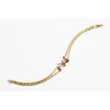 A ruby and diamond 18ct gold bracelet, set with four marquise cut rubies and three brilliant cut