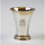 A German white metal cup, of plain polished tapering form, rope twist detail to the stepped base,