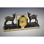 A 1930's French Art Deco mantel clock, the marble case surmounted with a pair of bronzed deer,