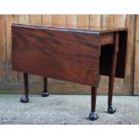 A George III mahogany drop leaf table, the rectangular top upon cylindrical tapering legs with