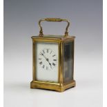 A 19th century lacquered brass carriage clock, with a 7cm white enamel dial, two train movement