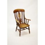 A 19th century elm, beech and alder wood farmhouse Windsor elbow chair, with a pierced vase shaped