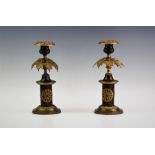 A Pair of early 20th century continental gilt metal candlesticks, the Roman doric columns applied