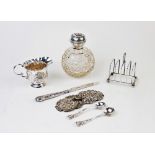 A silver topped perfume bottle, Henry Matthews, Birmingham 1907, with globular cut glass body,