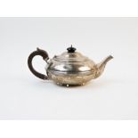 An Edwardian silver tea pot, Goldsmiths & Silversmiths Co, London 1909, of plain polished form, with