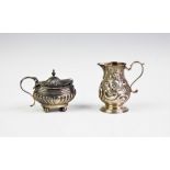 A George II silver cream jug, London 1737, with sparrow beak lip, all decorated with foliate