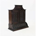 A late Victorian oak desk top cabinet, the pagoda shaped pediment carved with the date '1899', above