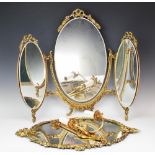 A gilt metal oval wall mirror, with foliate and bow surround enclosing a mirror plate, 62cm high,