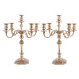 COPPIA CANDELABRI a cinque fiamme in argento (g. 5060). XX secolo Misure: h cm 47