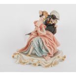 GRUPPO in biscuit Capodimonte raffigurante "Arlecchino con dama" firmato in basso, base in legno