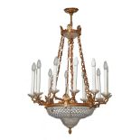 LAMPDARIO stile Impero a dodici fiamme in bronzo dorato con coppe e piattini in cristallo. Italia