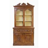 BOOKCASE a due ante in mogano intagliato. Inghilterra XIX secolo Misure: cm 120 x 44 x h 234