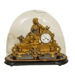 OROLOGIO in metallo dorato con scultura superiore raffigurante "Donna sdraiata", base in legno