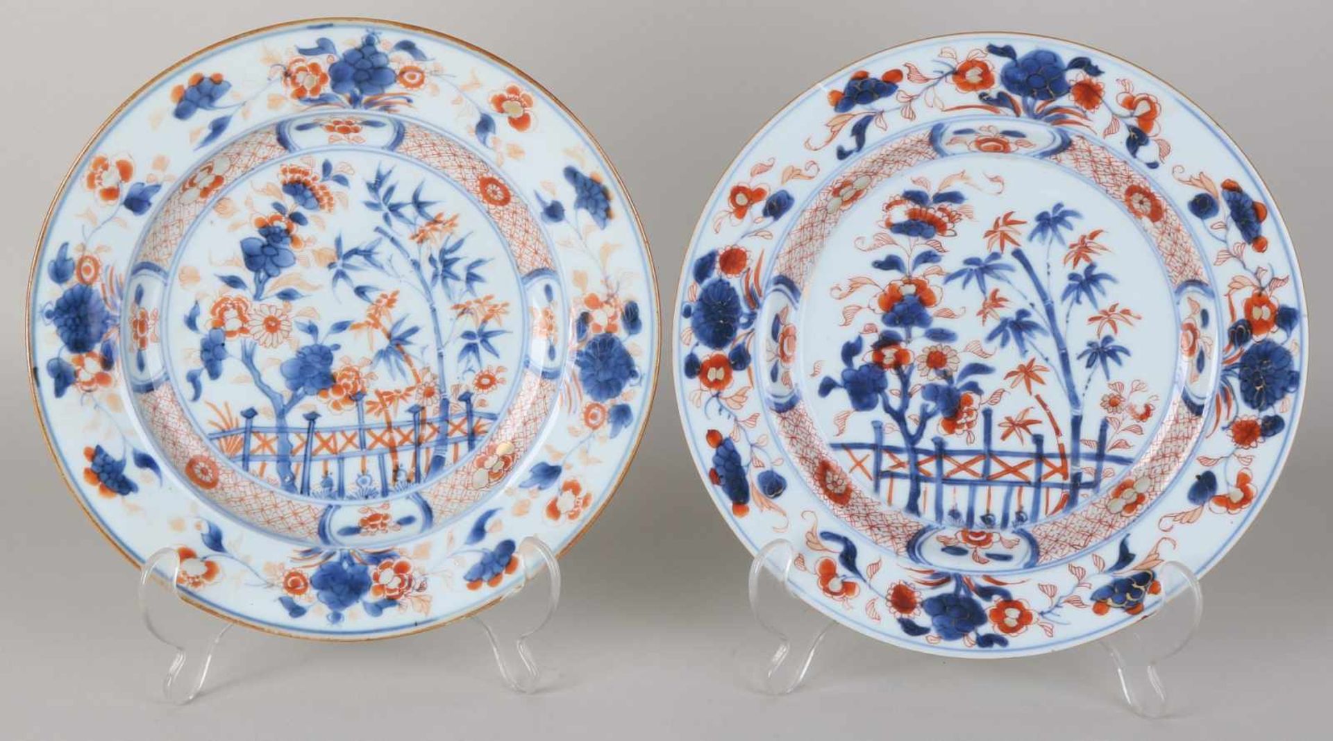 Two 18th century Chinese Imari porcelain plates with garden decor. Twice hairline + chip. Size: ø 23