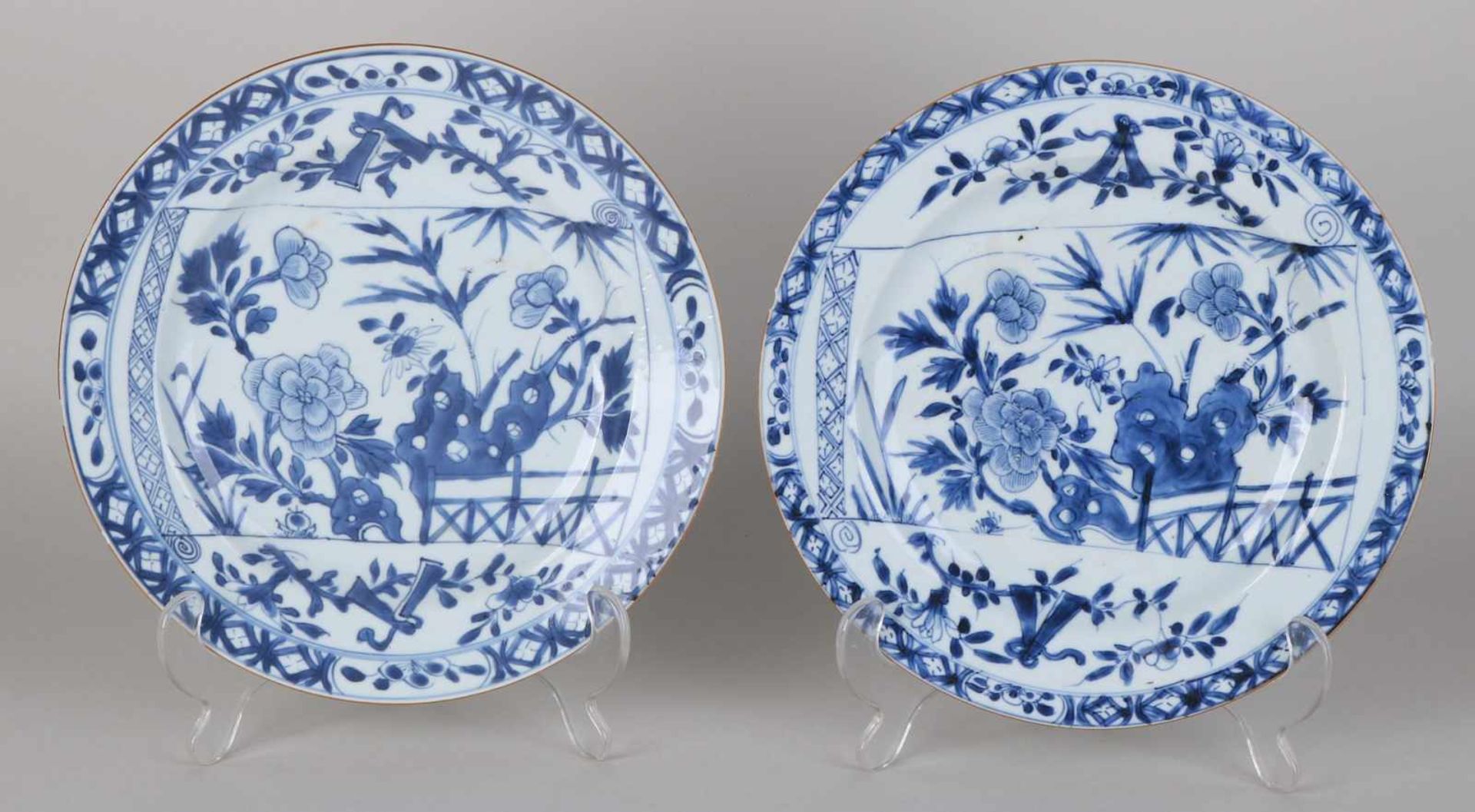 Two 18th century Chinese porcelain plates with garden decor. One plate of hairline + edge damage.