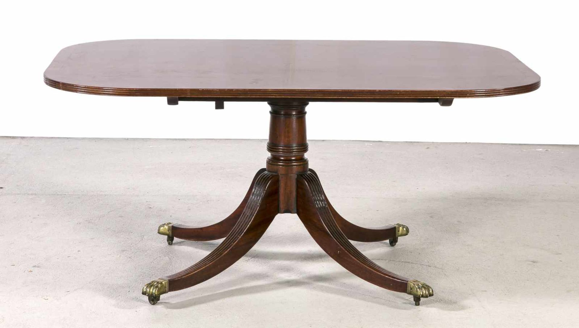 English mahogany dining table with copper claw feet and wheels. 20th century. Dimensions: 71 x 104 x