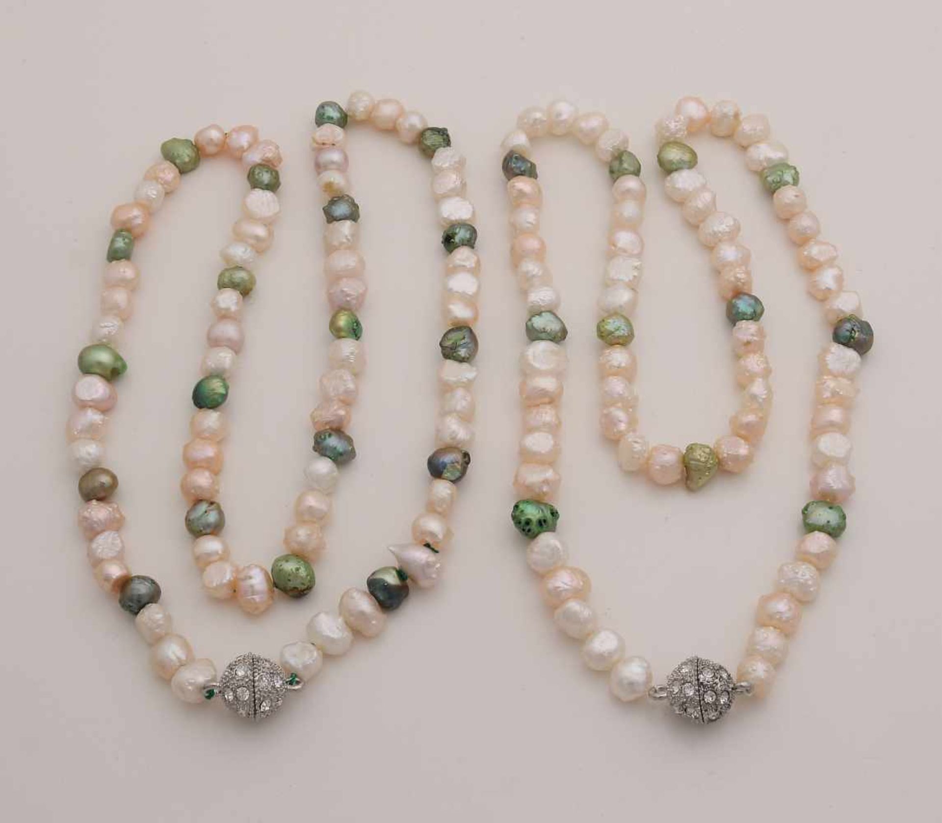 Two necklaces of whimsical freshwater pearls, mixed with green pearls and fitted with a white