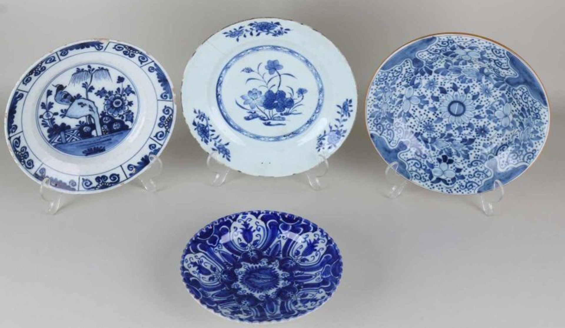 Four 18th - 19th century porcelain and Delft Fayence plates. One time floral folding dish, bottom