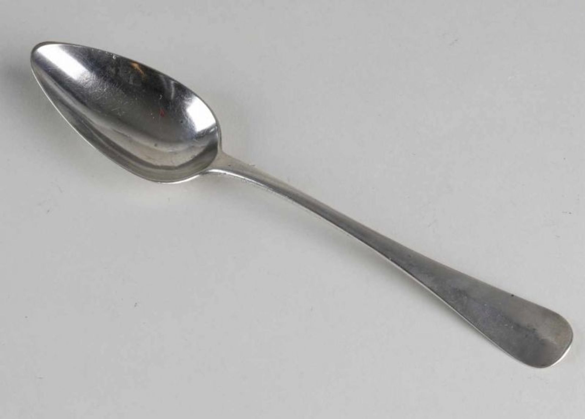 Antique 835/000 silver spoon with Haags Lof. Backside handle engraved family crest. Length 21 cm.