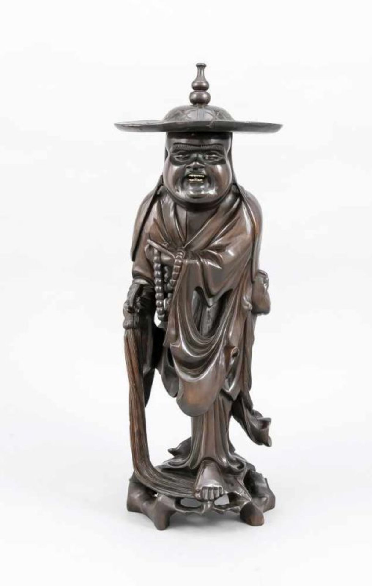 Old oriental wood carving. Chinese man with hat and bead necklace. Porcelain eyes and teeth. 20th