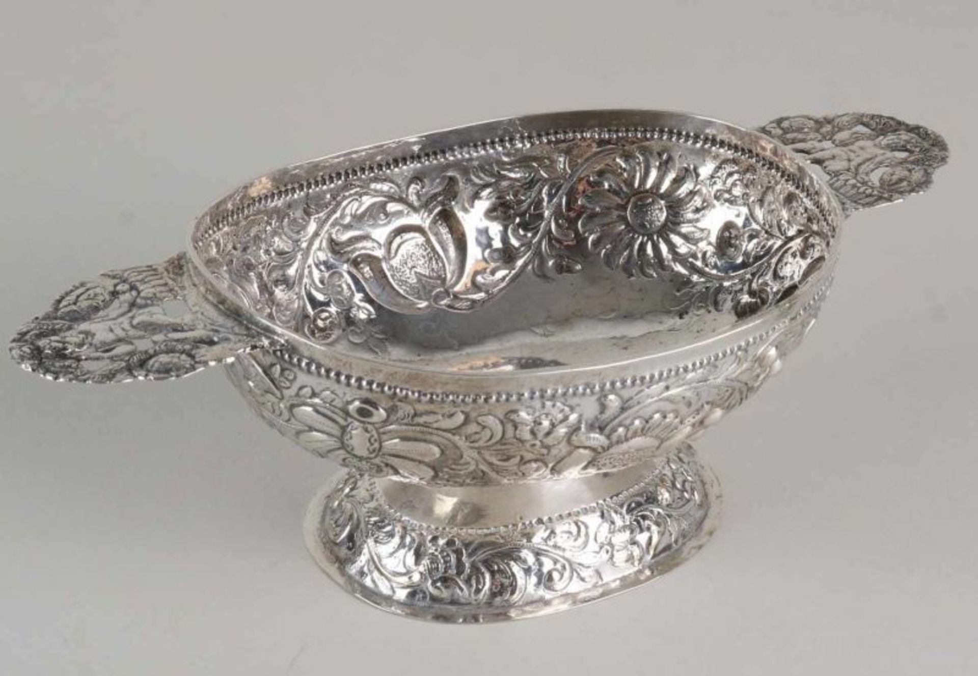 Frisian silver brandy bowl, 18th century, decorated with driven floral images, truss work and two