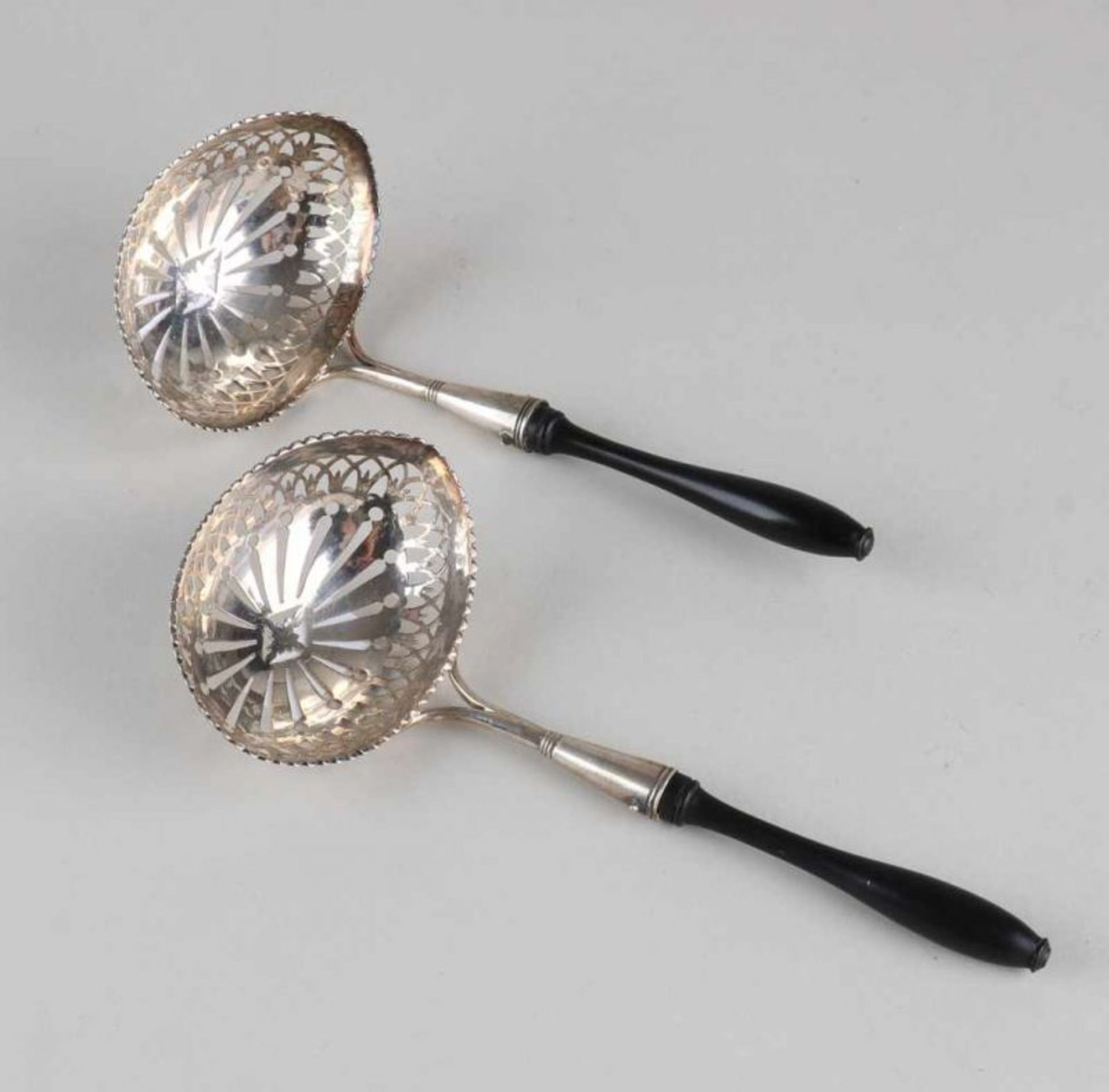 Two identical silver scoop spoons, 833/000, with a barge-shaped bowl with a scalloped edge and