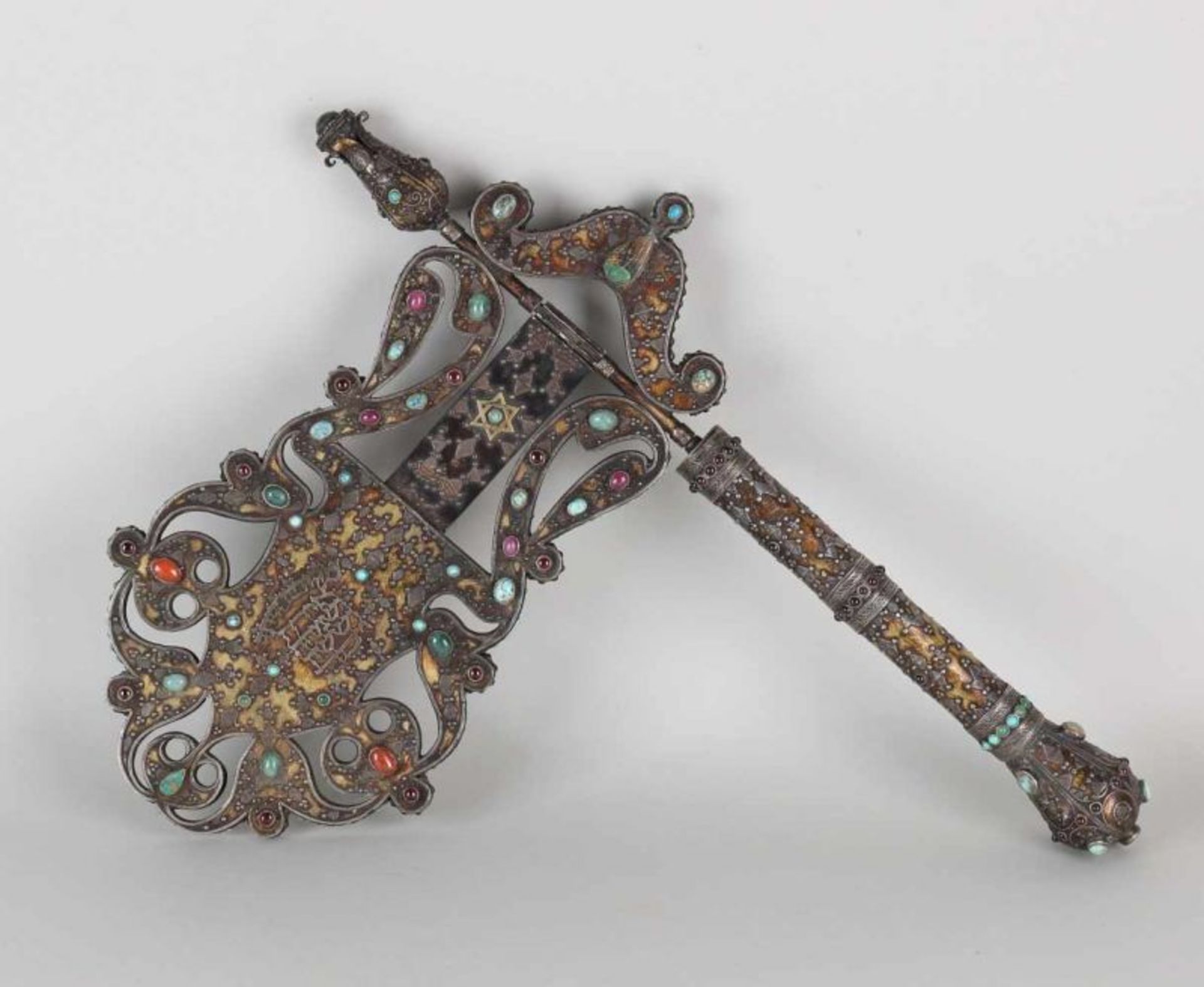 Old brass Judaica synagogue ratchet with star of David and text. Set with turquoise, agate, ruby
