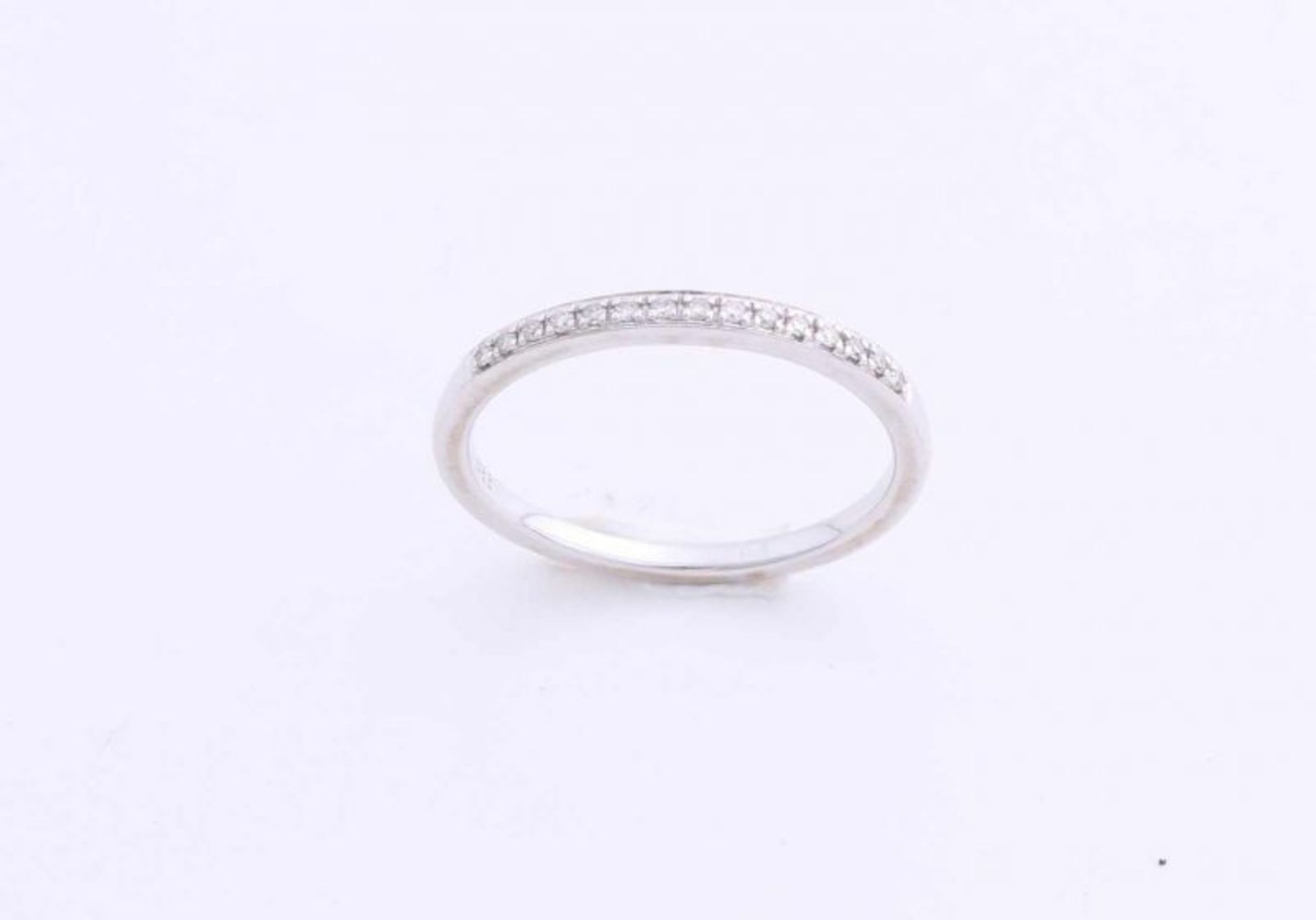White gold on sliding ring, 585/000, with diamond. Narrow ring half set with diamonds, total about