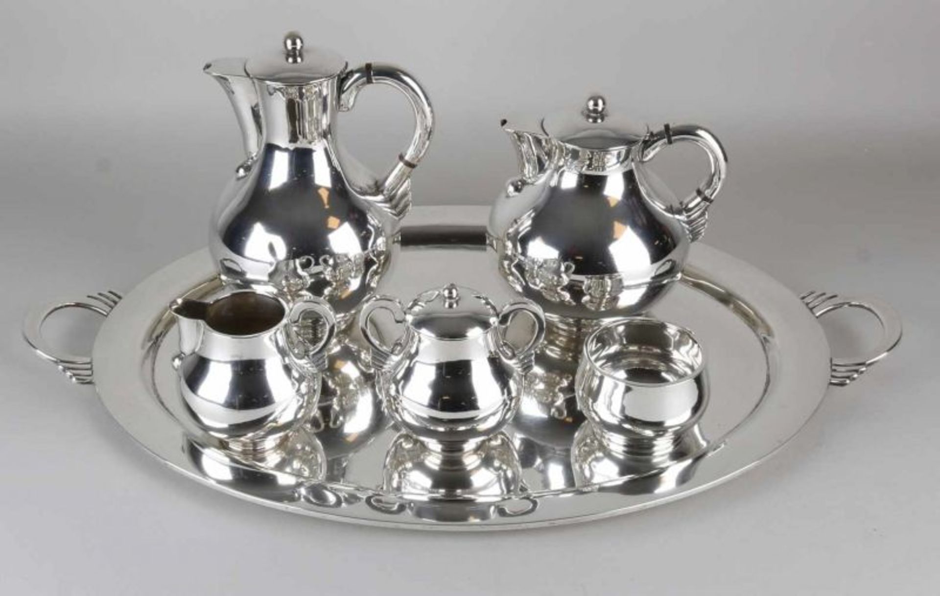 Modern silver coffee service, 925/000, placed on an oval large tray, equipped with a coffee pot, tea