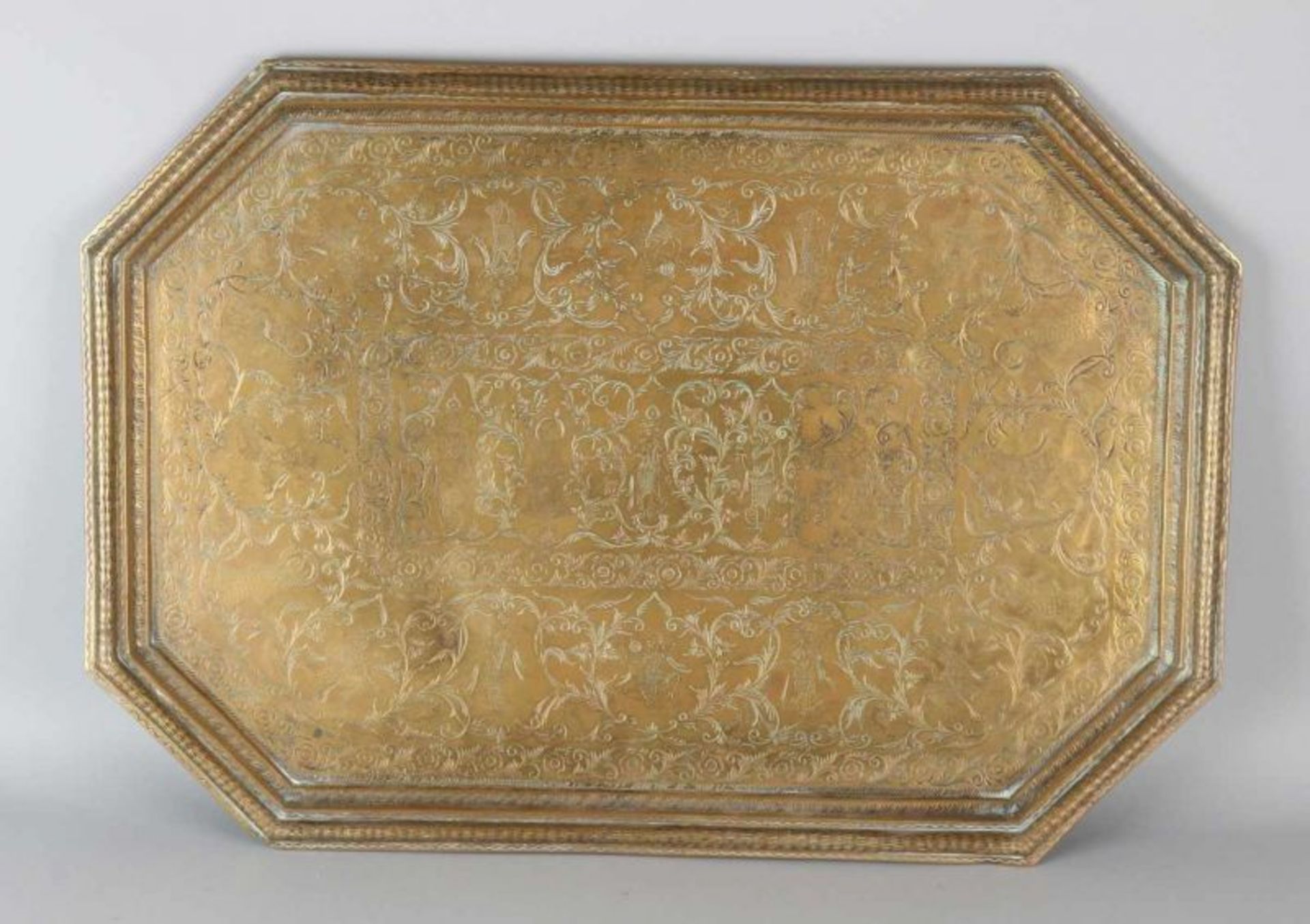 Large antique Oriental decorated brass tablet with figures and tendrils. Dimensions: 49 x 68 cm.