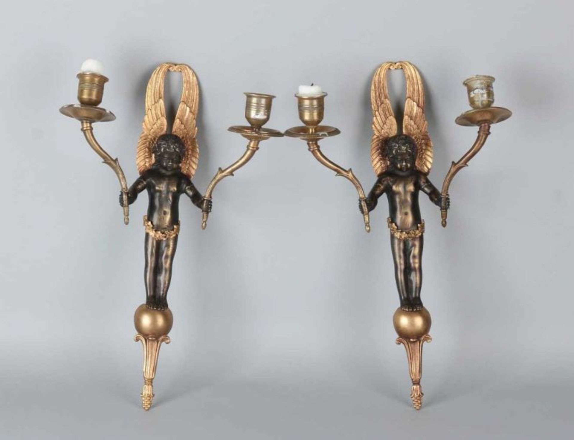 Two 19th-century bronze Empire-style wall candle holders, partly in a bun. Dimensions: 36 cm. In