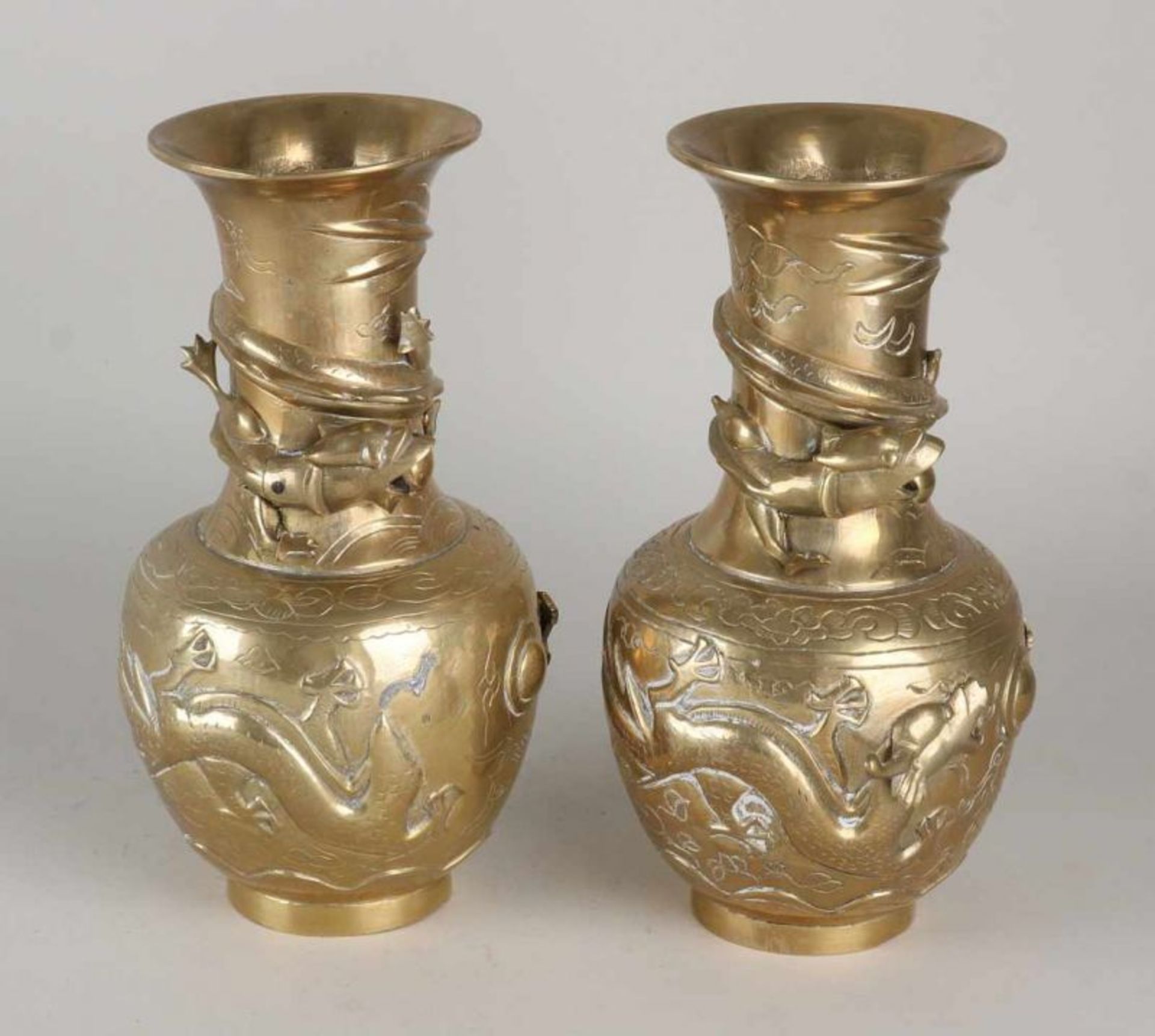 Two antique Chinese brass ornamental vases with dragons and bottom brand. Circa 1930. Dimensions: