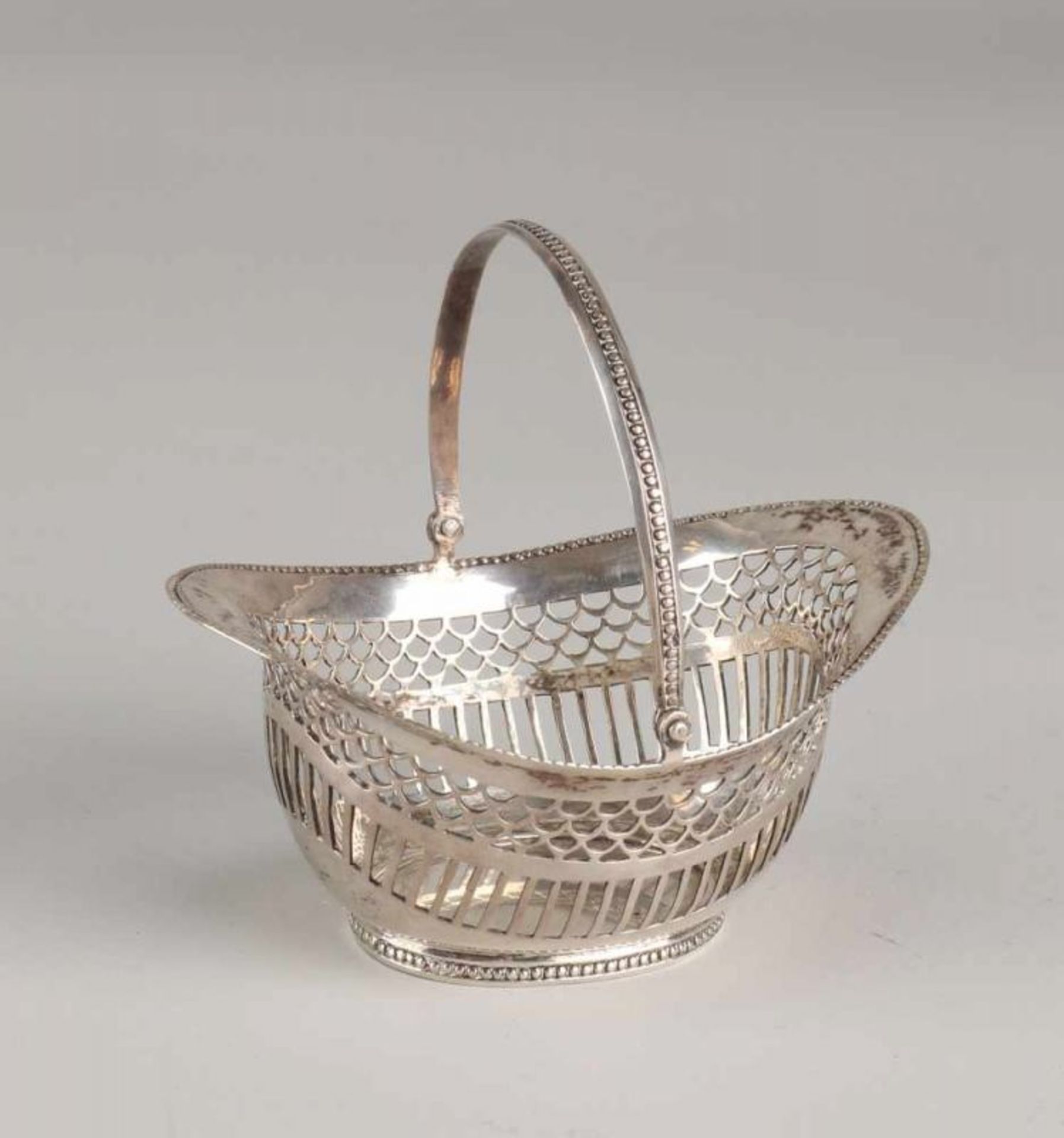 Silver tangle basket, 833/000, oval model with a sawn bars and semi-circle pattern. Placed on an