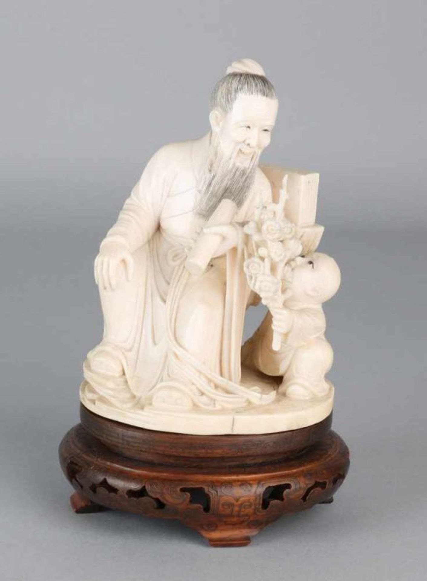 19th century Japanese ivory figure. Japanese old man with child and blossom branch. On a wood
